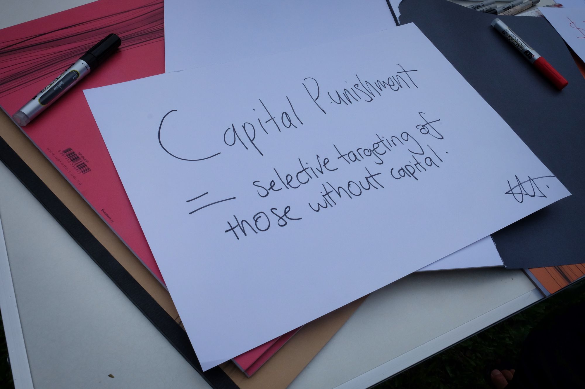 A placard that reads: "Capital Punishment = Selective Targeting of Those Without Capital"