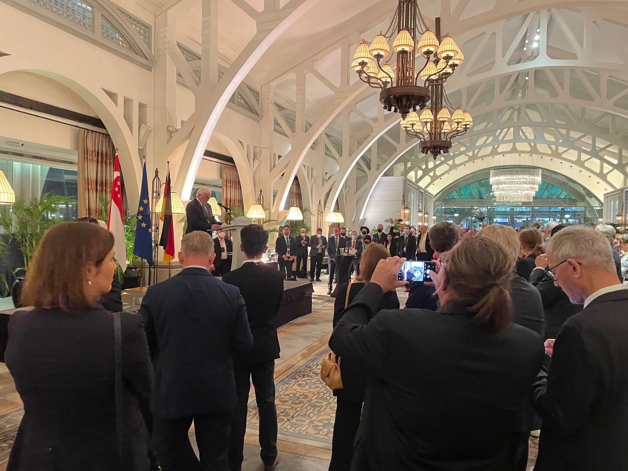 A wide shot of people dressed in business attire gathered at Clifford Pier for a reception hosted by the German embassy.